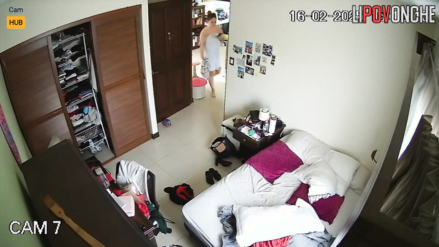 Tattooed naked Costa Rican woman hangs out on her phone after a shower