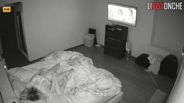 The husband relaxes while watching TV while his wife gives him a blowjob