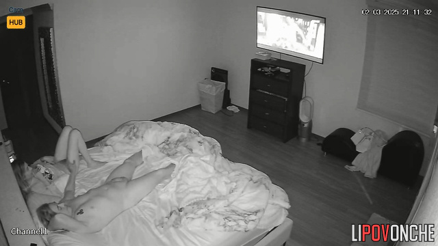 The husband relaxes while watching TV while his wife gives him a blowjob