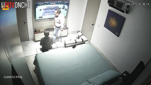 An older man has intercourse with a slender Colombian prostitute while watching tennis