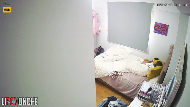 A young beauty with a voluptuous, seductive butt watches porn in her bed