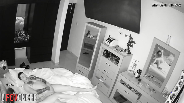 A pretty girl caresses her husband's tattooed body while giving him a blowjob