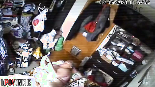 A naked, fat milf watches porn on her phone while her husband sleeps
