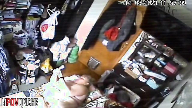 A naked, fat milf watches porn on her phone while her husband sleeps