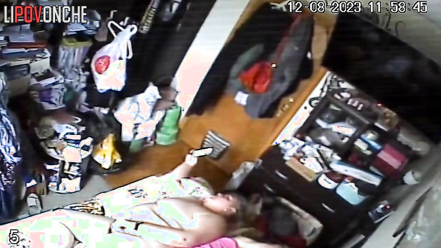 A naked, fat milf watches porn on her phone while her husband sleeps