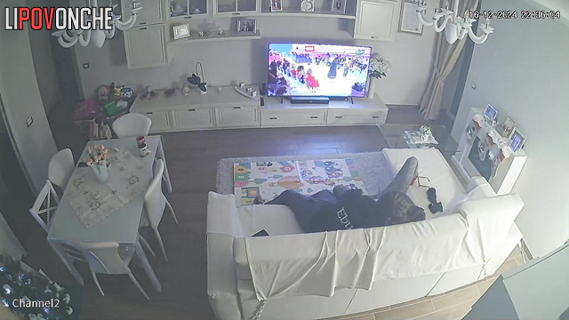 A young couple is trying out new sex positions on a large sofa