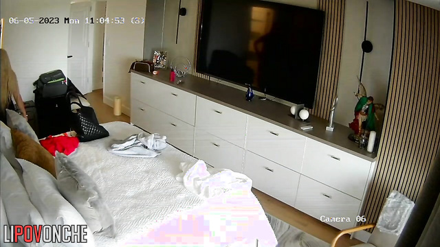 A stylish blonde walks around the room completely naked, getting ready to go for a walk