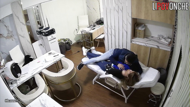 A male doctor fondles his attractive patient's breasts on a daybed