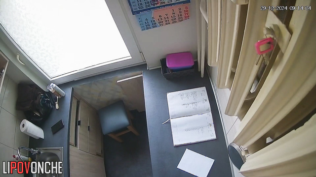 Naked lady spends her time at the kitchen and scrolls her phone
