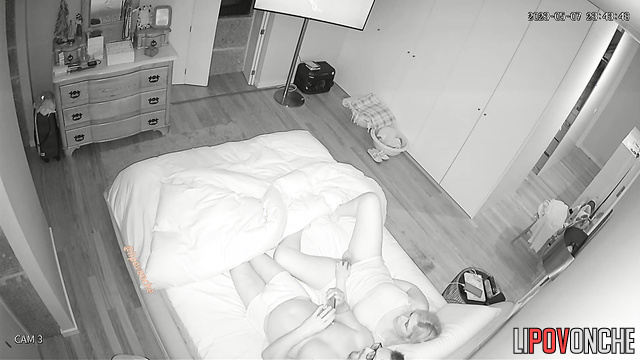 She satisfies herself while lying next to her husband on the bed