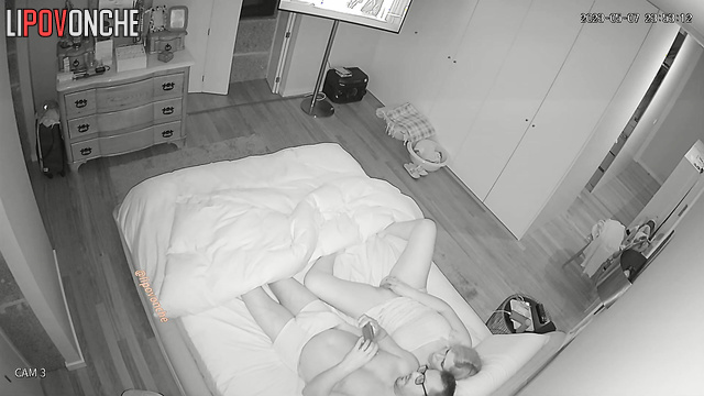 She satisfies herself while lying next to her husband on the bed