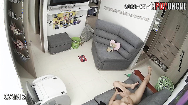 Sexy girl relaxing on the sofa with her phone, completely naked