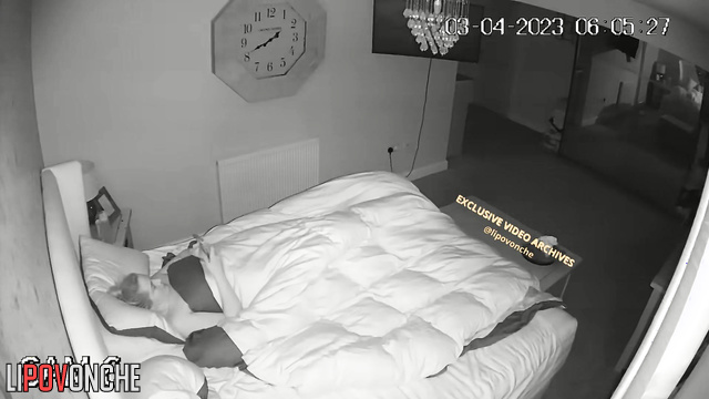 A completely naked red-haired woman makes the bed after morning sex