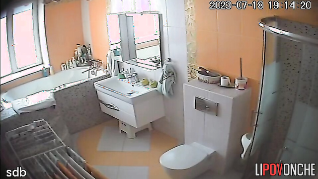 A young naked beauty lets her elderly mother into the bathroom to pee