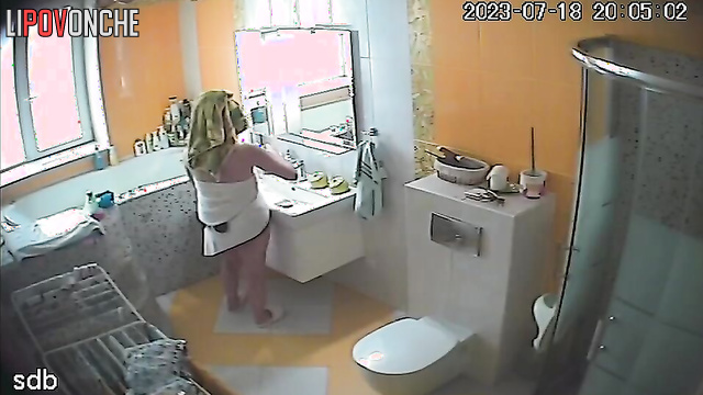 A young naked beauty lets her elderly mother into the bathroom to pee