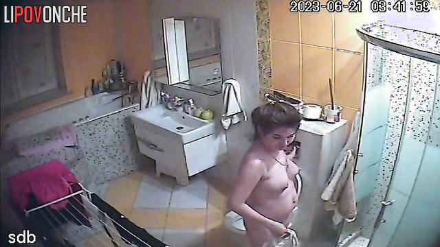 Young naked mom with tender tits plays with her pussy after peeing