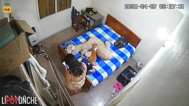 A young Argentinean woman chooses what to wear after her shower