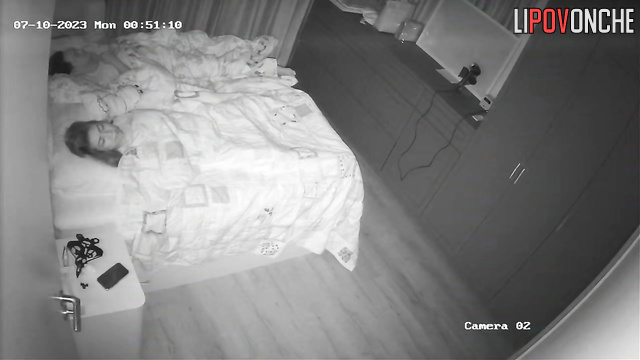Husband is sleeping and doesn't know what she's doing under the blanket