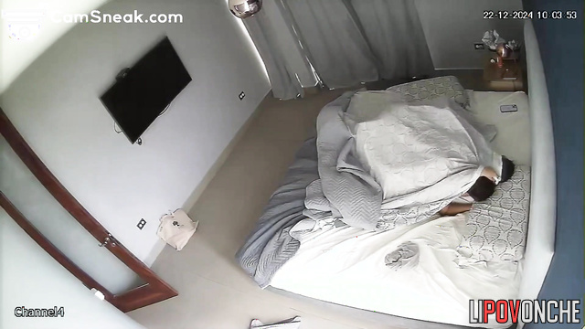 Young couple kissing and hugging in bed, hidden cam