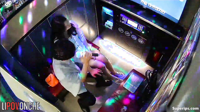 Asian couple singing their favorite songs at karaoke club