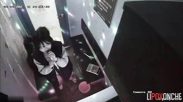 Asian couple kissing in karaoke booth (teens having fun)