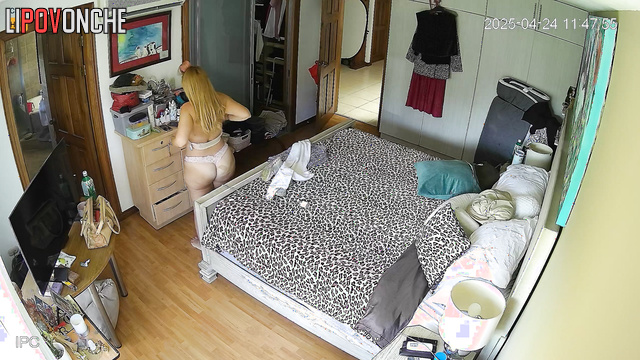 Blonde walks around the room and doesn't realize that she is being watched