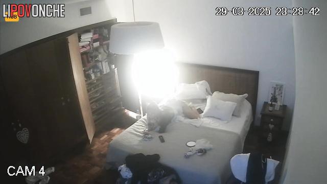 Blonde chatting with her friends lying on the bed