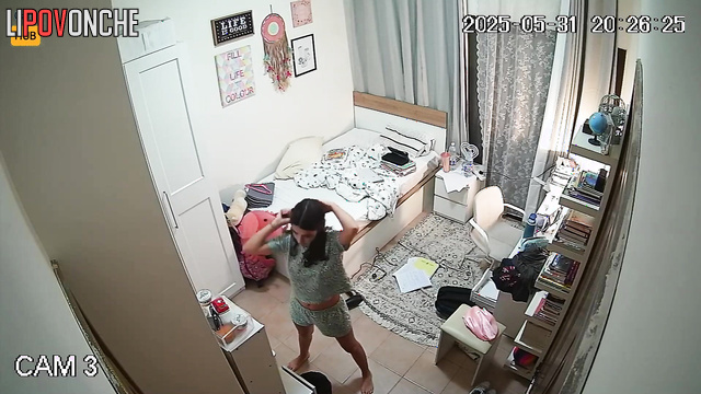 Petite brunette singing and looking at herself in the mirror