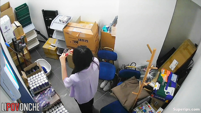 Young Korean women change into uniforms in a small office room