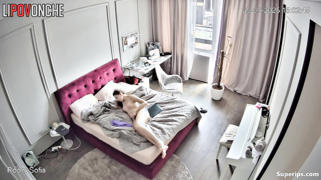 A seductive beauty plays with her hair on her wet pussy while watching a video