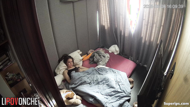 A young girl plays with her hairy pussy while watching porn on her phone