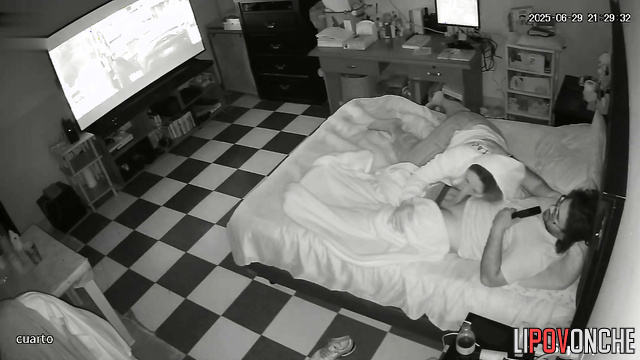The wife distracted her husband from watching the movie by caressing his cock