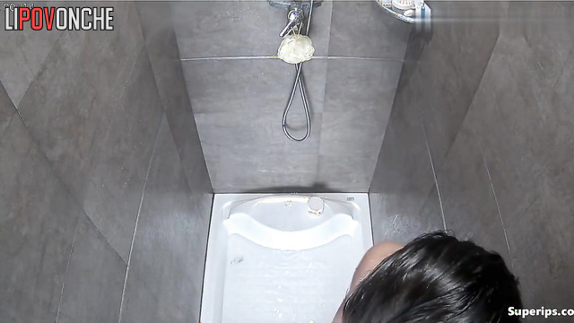 A seductive Asian girl caresses her sexy body while showering
