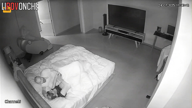 Adults fucking in bed, unaware their joy is being filmed