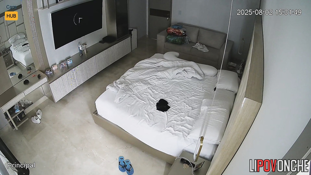 Horny people lying in bed, unaware a hidden lens records them
