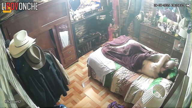 Wife and husband rest together, blind to the secret surveillance