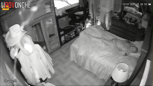 Spouses resting together, blind to the secret surveillance