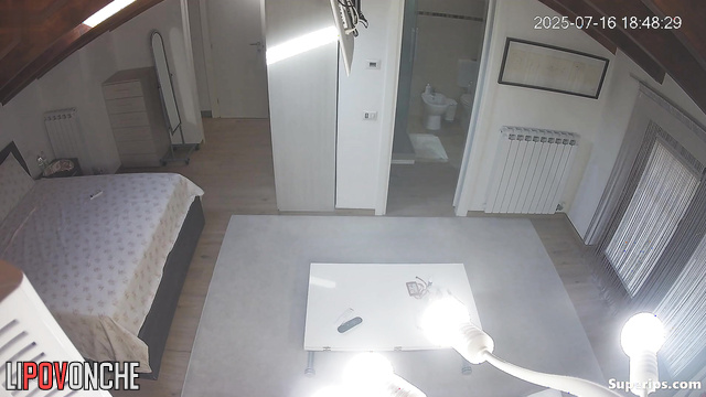 A young, skinny student walks around her bedroom completely naked