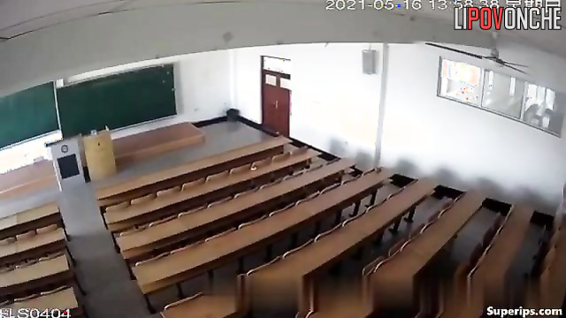 Young students actively engage in sexual activity in a large lecture hall