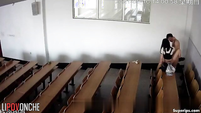 Young students actively engage in sexual activity in a large lecture hall