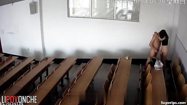Young students actively engage in sexual activity in a large lecture hall