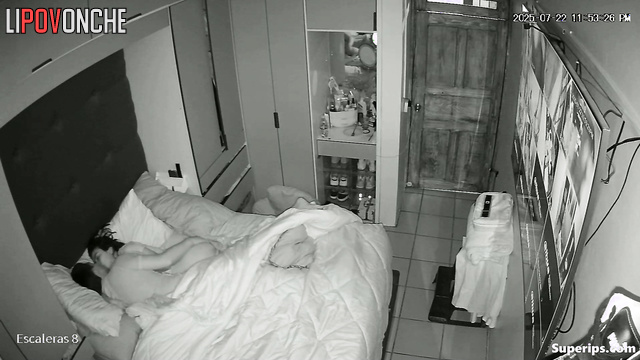 A married couple watches guests on cameras while having sex