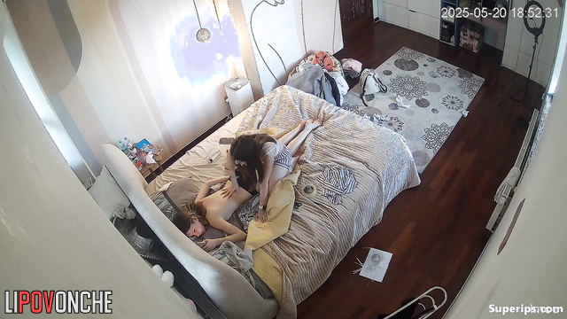 One teenager giving another a massage (one of them is topless)