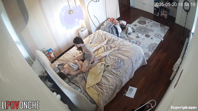 One teenager giving another a massage (one of them is topless)
