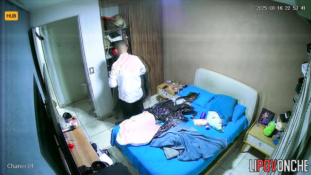 Couple gets dressed and unaware there is a tiny cam installed above the door