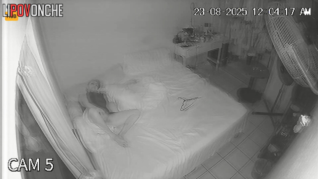 A bored blonde spreads her labia in front of a fan blowing on her cunt
