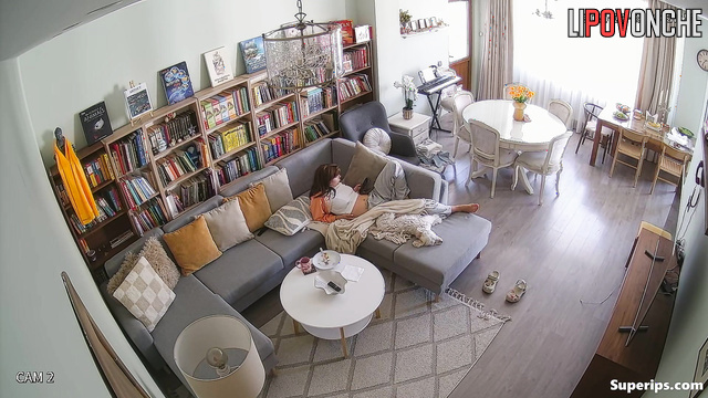 Young lady masturbating in a cozy living room, look