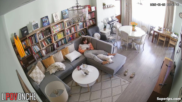 Young lady masturbating in a cozy living room, look