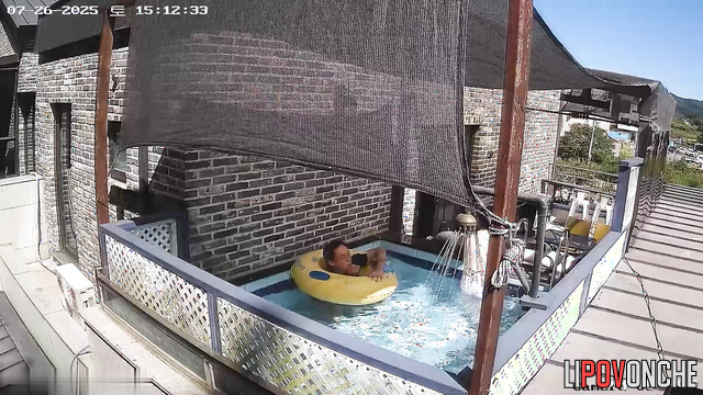 Asian couple swimming in their backyard pool, look