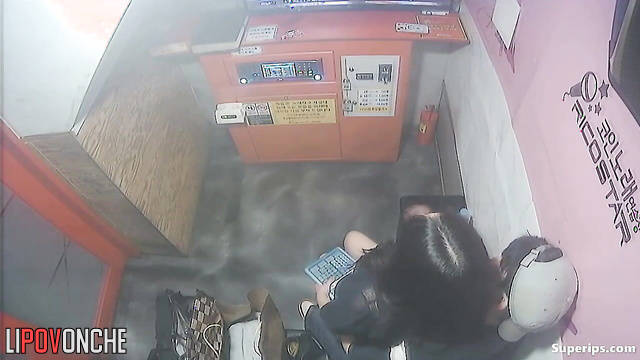 Asian teens teasing each other at a karaoke club, look